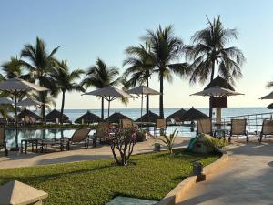 a resort with chairs and umbrellas and the ocean at Bay View Grand Ixtapa Exclusive in Ixtapa