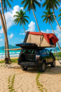 a car with a tent on top of it on the beach at قولد شير 2 in Salalah