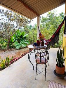 a table and a chair on a patio at Chalé dos Lírios in Alto Paraíso de Goiás