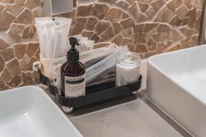 a bottle of alcohol sitting on a shelf next to a toilet at GOYOO INN & cabins in Seoul +43 photos