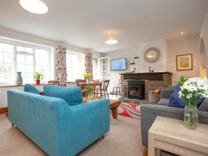 a living room with blue furniture and a fireplace at Tuckenhay, 1 Salle Cottage, - Fcq in Ashsprington +46 photos