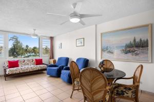 a living room with a couch and a table and chairs at Playa Azul Beach by Otium in Luquillo