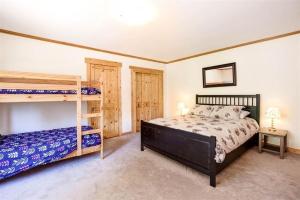 a bedroom with two bunk beds and a bedskirts at Carnelian Bay Lake House in Carnelian Bay