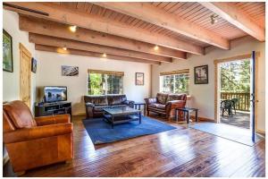 a living room with leather furniture and a porch at Carnelian Bay Lake House in Carnelian Bay
