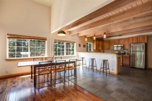 a large kitchen with a table and some chairs at Carnelian Bay Lake House in Carnelian Bay