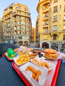 a table with a tray of food and french fries at Excellent Location cairo in Cairo