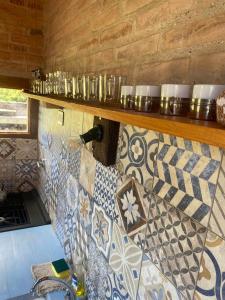 a kitchen with a counter with tiles on the wall at Casas de Epoca -Serendipia in Charbonier