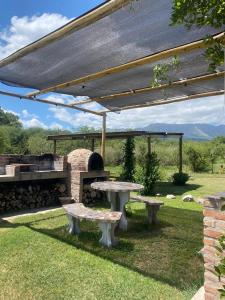 a picnic table and a stone oven in a yard at Casas de Epoca -Serendipia in Charbonier