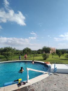 a group of people standing around a swimming pool at Casas de Epoca -Serendipia in Charbonier
