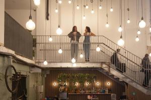 two women standing on a staircase in a building at Little Drifter Melbourne in Melbourne