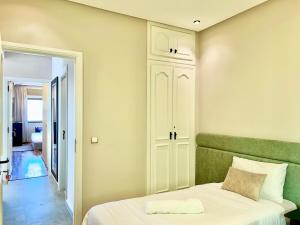 a bedroom with a bed with a green headboard at 360 Oceanfront & Sunset View Condo - Terrace & 2BR in Tangier