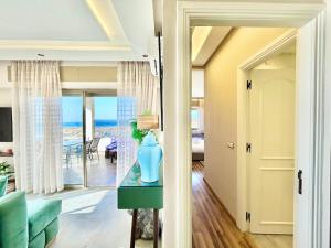 a living room with a blue vase on a table at 360 Oceanfront & Sunset View Condo - Terrace & 2BR in Tangier