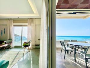 a dining room with a table and a view of the ocean at 360 Oceanfront & Sunset View Condo - Terrace & 2BR in Tangier