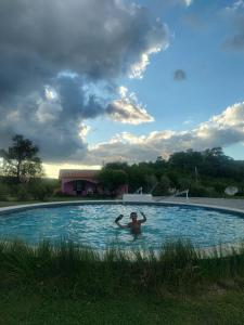 a man in a swimming pool in a yard at Casas de Epoca -Limerencia in Charbonier +48 photos