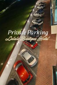 a group of cars parked in a parking lot at Lulala Boutique Hotel in Gerik
