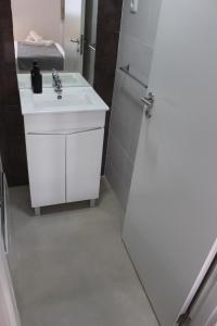 a white bathroom with a sink and a shower at Jardim da Trindade in Coimbra +43 photos