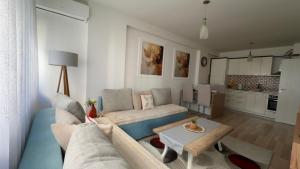 a living room with a couch and a table at Sweet Home in Kosovo Polje