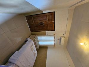 a small room with a bed and a cabinet at Cemara Paradise Homestay in Pulau Gilimelayu