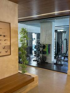 a gym with a large glass window with tread machines at Piratininga a Beira Mar - Niterói in Niterói
