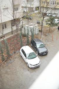 two cars parked next to each other on a street at Sweet Home in Kosovo Polje