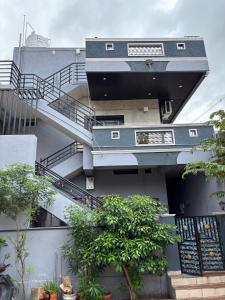 a building with a spiral staircase on the side of it at Aras Homestay New Hampi in Hampi +7 photos