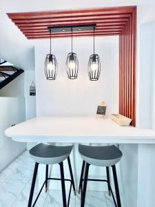 a kitchen with a white table and two chairs at 2 Beds Spacious Centrally Located Loft Apartment in Naga