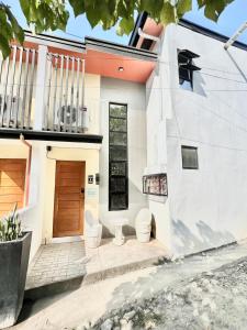 a white house with toilets in front of it at 2 Beds Spacious Centrally Located Loft Apartment in Naga