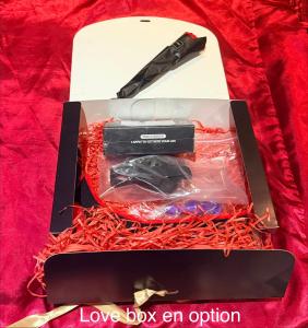 a box with a knife in it on a bed at Love Room L Interlude in Vitrolles