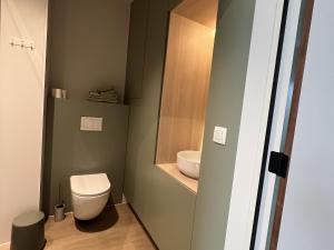 a small bathroom with a toilet and a sink at Attractive apartment in Bree for 2 guests in Bree +11 photos