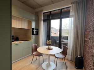 a kitchen and dining room with a table and chairs at Attractive apartment in Bree for 2 guests in Bree