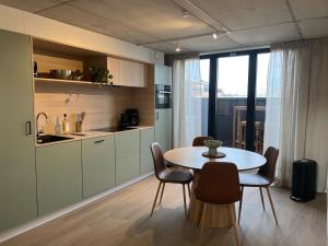 a kitchen and dining room with a table and chairs at Inviting apartment in Bree with terrace in Bree