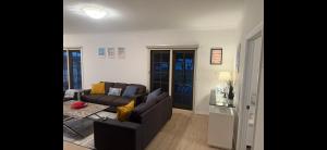 a living room with a couch and a table at Waters Edge Retreat in Dawesville
