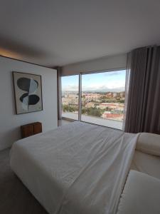 a bedroom with a large bed and a large window at Deluxe 2 Terraces River&Marina View Flat in Ferragudo