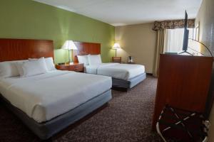 a hotel room with two beds and a window at Quality Inn & Suites Downtown Mansfield in Mansfield