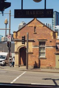 a brick building with an archway on a city street at Glasgow Arms Hotel Ultimo in Sydney