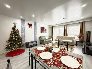 a living room with a christmas tree in it at Spacious 2 BR Suite with Parking, Backyard & Desk in Toronto +5 photos