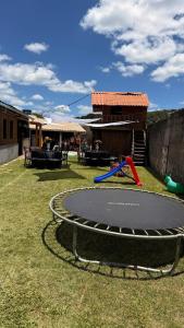 a playground with a trampoline in a yard at Sitio em Capim Branco in Capim Branco