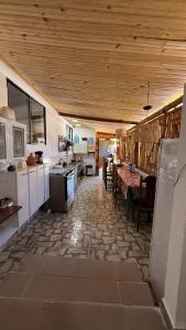 a kitchen and dining room with a table and appliances at Sitio em Capim Branco in Capim Branco