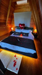 a bedroom with a bed with a red heart on it at Cabana Canto do Bugio in Gramado