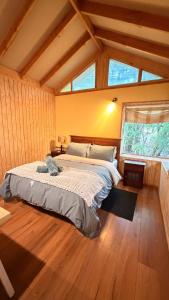 a bedroom with a large bed in a room at Cabaña Roca Volcán in Melipeuco +26 photos