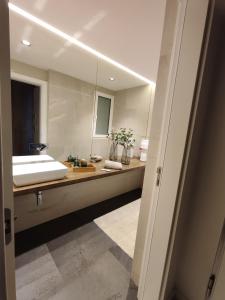 a bathroom with a sink and a large mirror at Terrace Ferragudo River View Flat Super in Ferragudo +21 photos