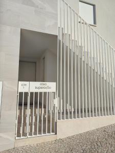 a gate with a sign in front of a building at Terrace Ferragudo River View Flat Super in Ferragudo