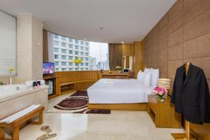 a hotel room with a bed and a bath tub at Paradise Saigon Boutique Hotel & Spa in Ho Chi Minh City