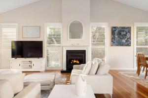 a living room with white furniture and a fireplace at Ivory Sands, Sorrento in Sorrento