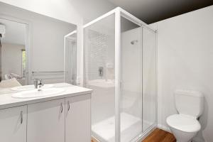 a white bathroom with a shower and a toilet at Ivory Sands, Sorrento in Sorrento +13 photos