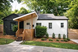 a small white house with a wooden deck at HPThe Bungalow Spectrum Bojangles Fenced Yard Dog in Charlotte
