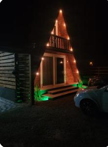 a house lit up at night with green lights at Chalé Ahmar! in Jaguaruna