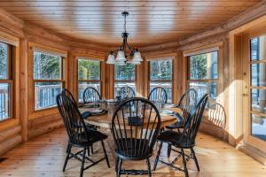 a dining room with a table and chairs at Fiddler Lake Resort - Deer 61 in Mille-Isles +23 photos