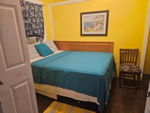 a small bedroom with a bed and a chair at 2#studio In Clearwater usa in Clearwater