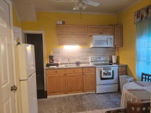 a kitchen with wooden cabinets and a white stove top oven at 2#studio In Clearwater usa in Clearwater